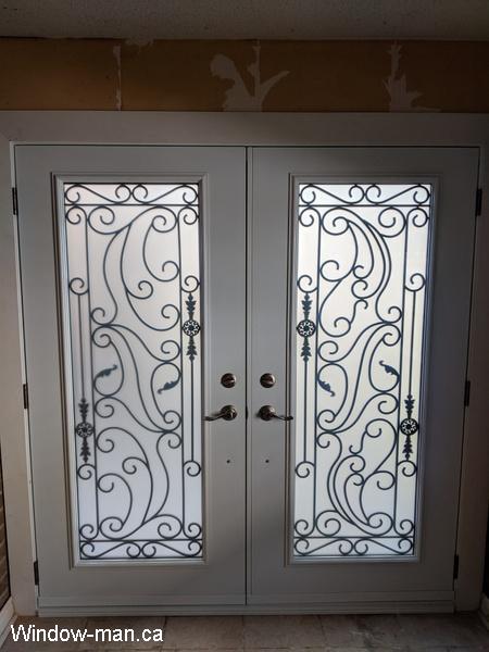 Double entry insulated front exterior doors. Brown. Santa Ana wrought iron glass design. Pic 1087 inside view